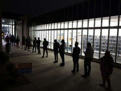 Residents wait in line to vote early outside a polling station on November 29, 2022, in Atlanta, Georgia.