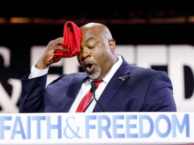 North Carolina Lieutenant Governor Mark Robinson wipes his brow as he speaks at the Faith and Freedom Road to Majority conference at the Washington Hilton on June 21, 2024, in Washington, D.C.