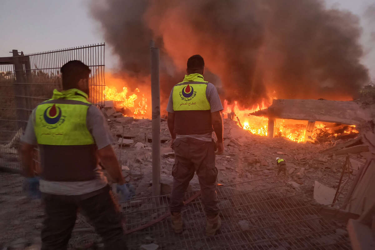 Rescuers rush to the scene of an Israeli airstrike that targeted the southern Lebanese village of Abbasiyeh on September 24, 2024.