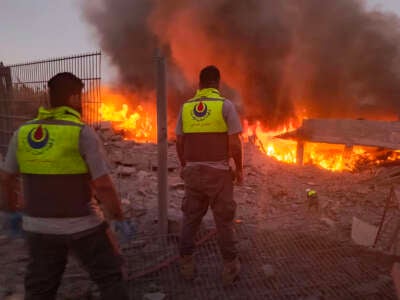 Rescuers rush to the scene of an Israeli airstrike that targeted the southern Lebanese village of Abbasiyeh on September 24, 2024.