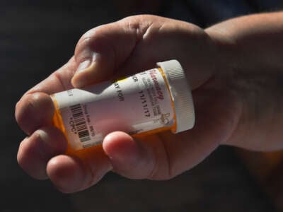 Elizabeth Cloinger holds an empty pill bottle that she hasnt refilled since losing Medicaid due to a work requirement, on March 22, 2019, in Marianna, Arkansas.