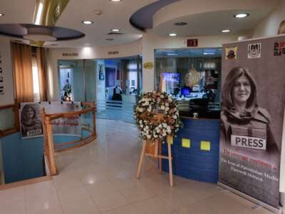 Pictures of slain Al Jazeera journalist Shireen Abu Akleh are displayed inside the news channel's office in the West Bank city of Ramallah on May 9, 2023