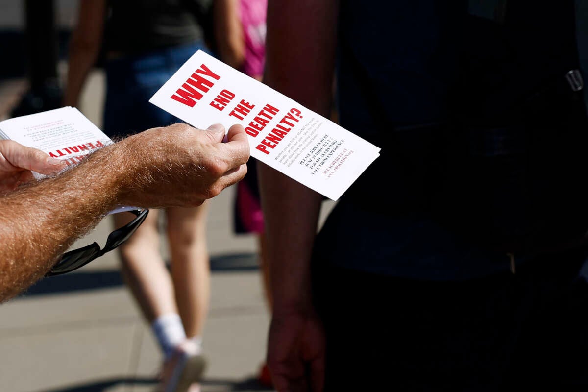 An activist with the Abolitionist Action Committee hands out brochures opposing the death penalty outside of the U.S. Supreme Court Building on July 2, 2024 in Washington, D.C.