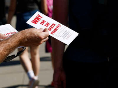 An activist with the Abolitionist Action Committee hands out brochures opposing the death penalty outside of the U.S. Supreme Court Building on July 2, 2024 in Washington, D.C.