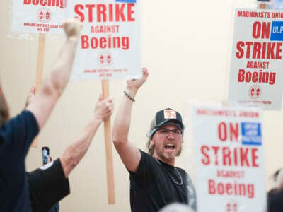 Union members react as Aerospace Machinists District 751 President Jon Holden (out of frame) announces that union members rejected a proposed Boeing contract and will go on strike, following voting results at their union hall in Seattle, Washington, on September 12, 2024.