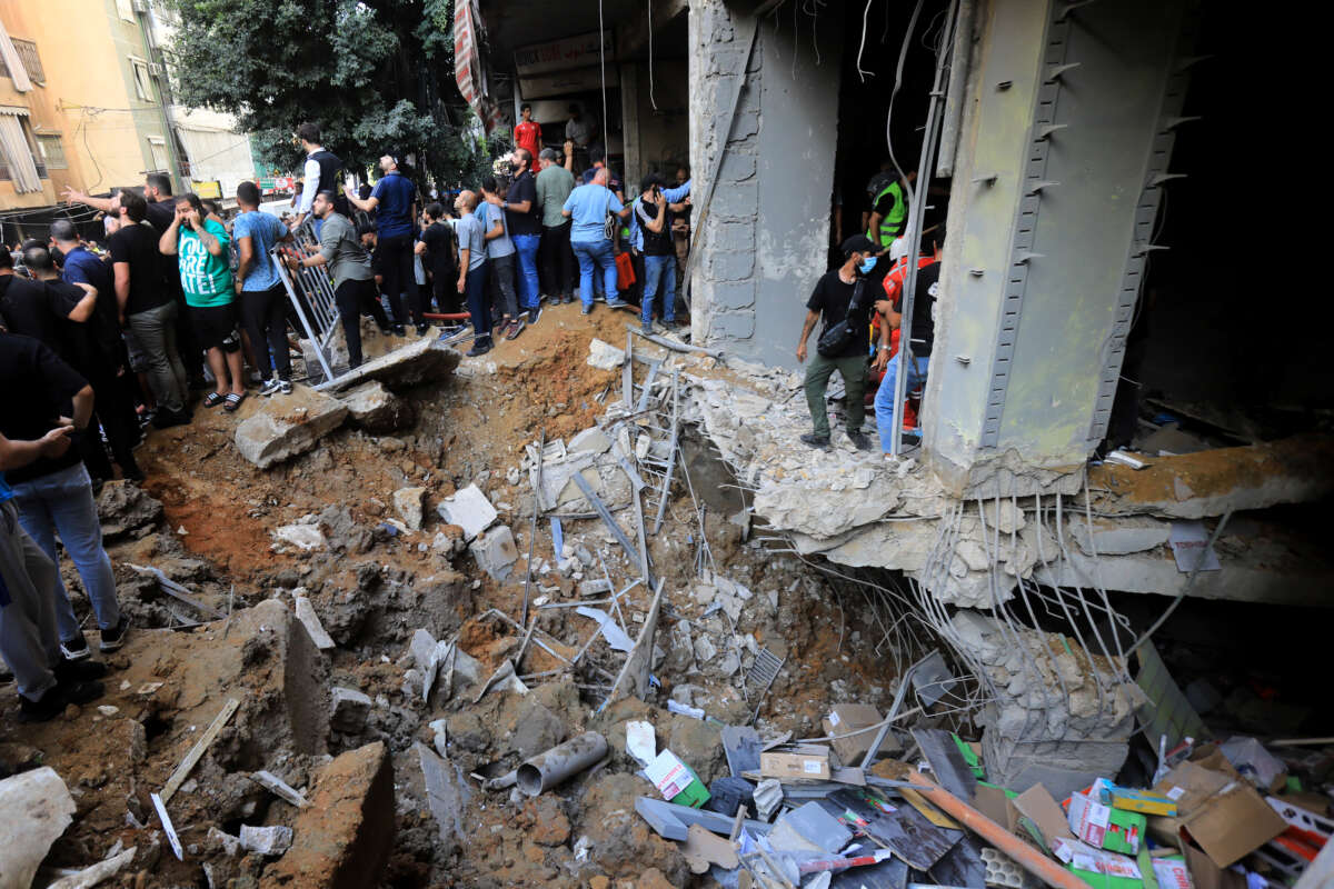 People gather near a crater caused by an Israeli air raid attack in a southern suburb of Beirut, Lebanon, on September 20, 2024.