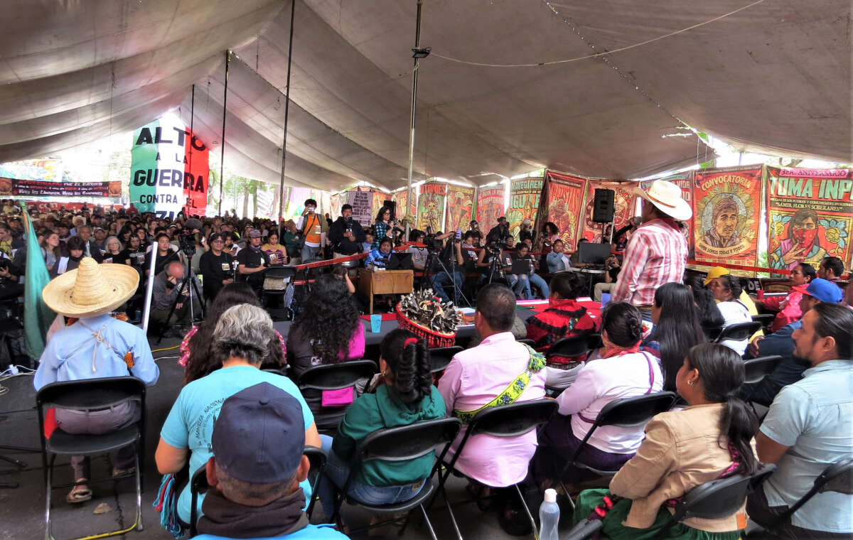 People sit and listen at an assembly