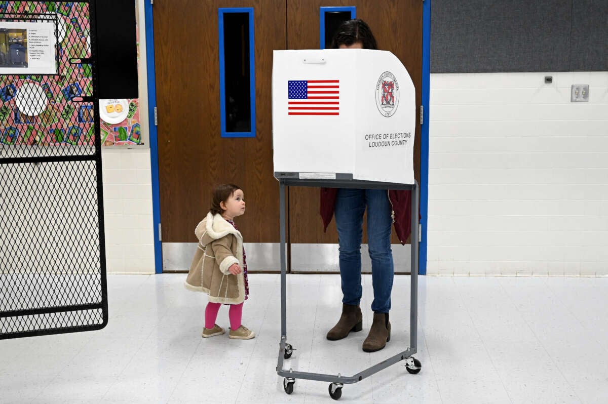 A child waits for her mother to vote at Evergreen Mills Elementary School on November 2, 2021, in Leesburg, Virginia.