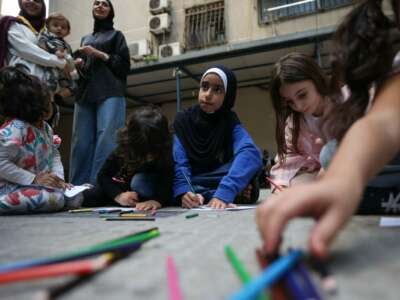 Children who fled Israeli bombardment in southern Lebanon, attend a drawing workshop organised by volunteers, at a shelter in Beirut where they took refuge with their families, on October 20, 2024.