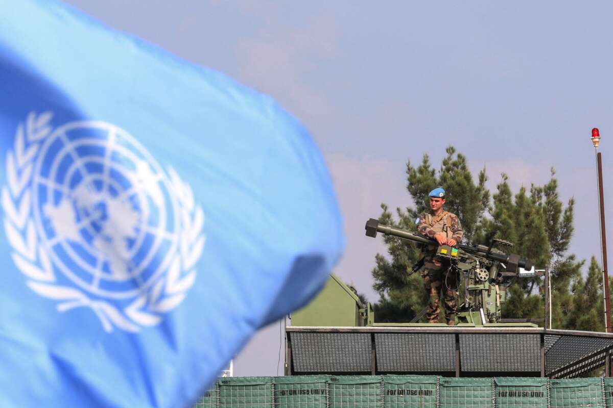 A member of the mine clearance team is pictured behind a UN flag during a tour by France's defence minister of the French contingent's United Nations Interim Forces in Lebanon (UNIFIL) base in the southern Lebanese village of Deir Kifa on November 2, 2023.