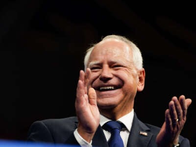 Democratic vice presidential candidate Minnesota Gov. Tim Walz applauds during a campaign event at Temple University's Liacouras Center in Philadelphia, Pennsylvania, on August 6, 2024.