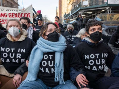 Members of the activist group Jewish Voice for Peace join others in protesting President Joe Biden's visit to Manhattan and calling for a ceasefire between Israel and Hamas, on February 7, 2024, in New York City.