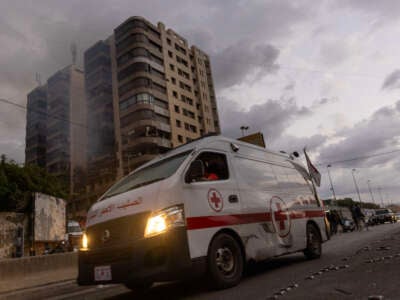 An ambulance leaves an apartment hit by an Israeli airstrike in the neighborhood of Jnah on October 1, 2024, in Beirut, Lebanon.