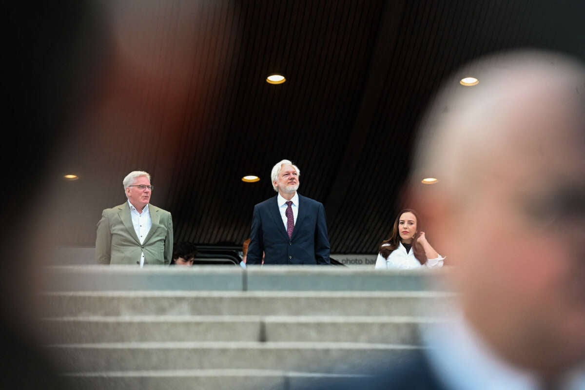 Julian Assange (center) and Kristinn Hrafnsson (left) arrive outside the Council of Europe, Strasbourg, France, on October 1, 2024.