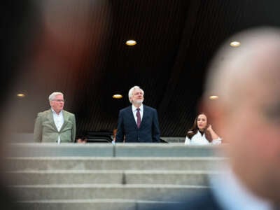 Julian Assange (center) and Kristinn Hrafnsson (left) arrive outside the Council of Europe, Strasbourg, France, on October 1, 2024.