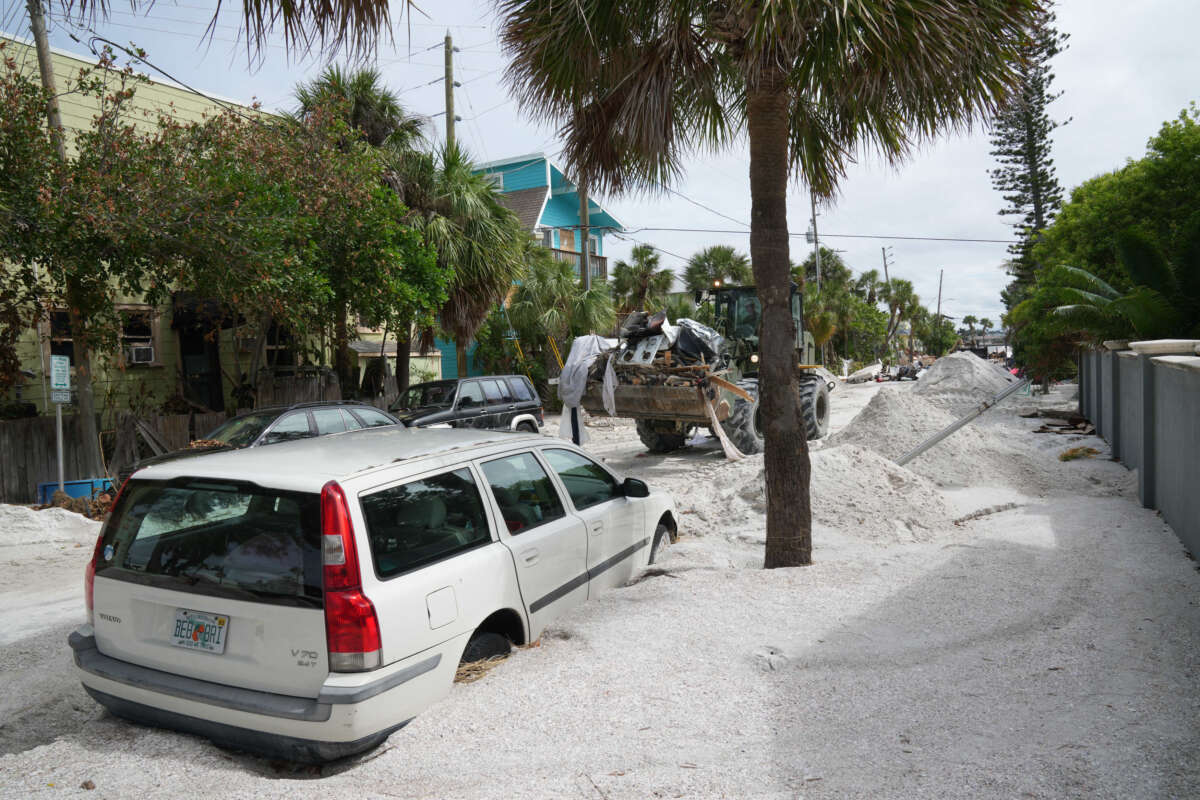 A Florida Army National Guard loader moves debris from the Pass-a-Grille neighborhood ahead of Hurricane Milton's expected landfall on October 7, 2024, in St. Petersburg, Florida.