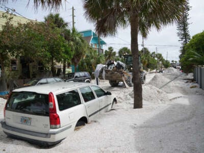 A Florida Army National Guard loader moves debris from the Pass-a-Grille neighborhood ahead of Hurricane Milton's expected landfall on October 7, 2024, in St. Petersburg, Florida.