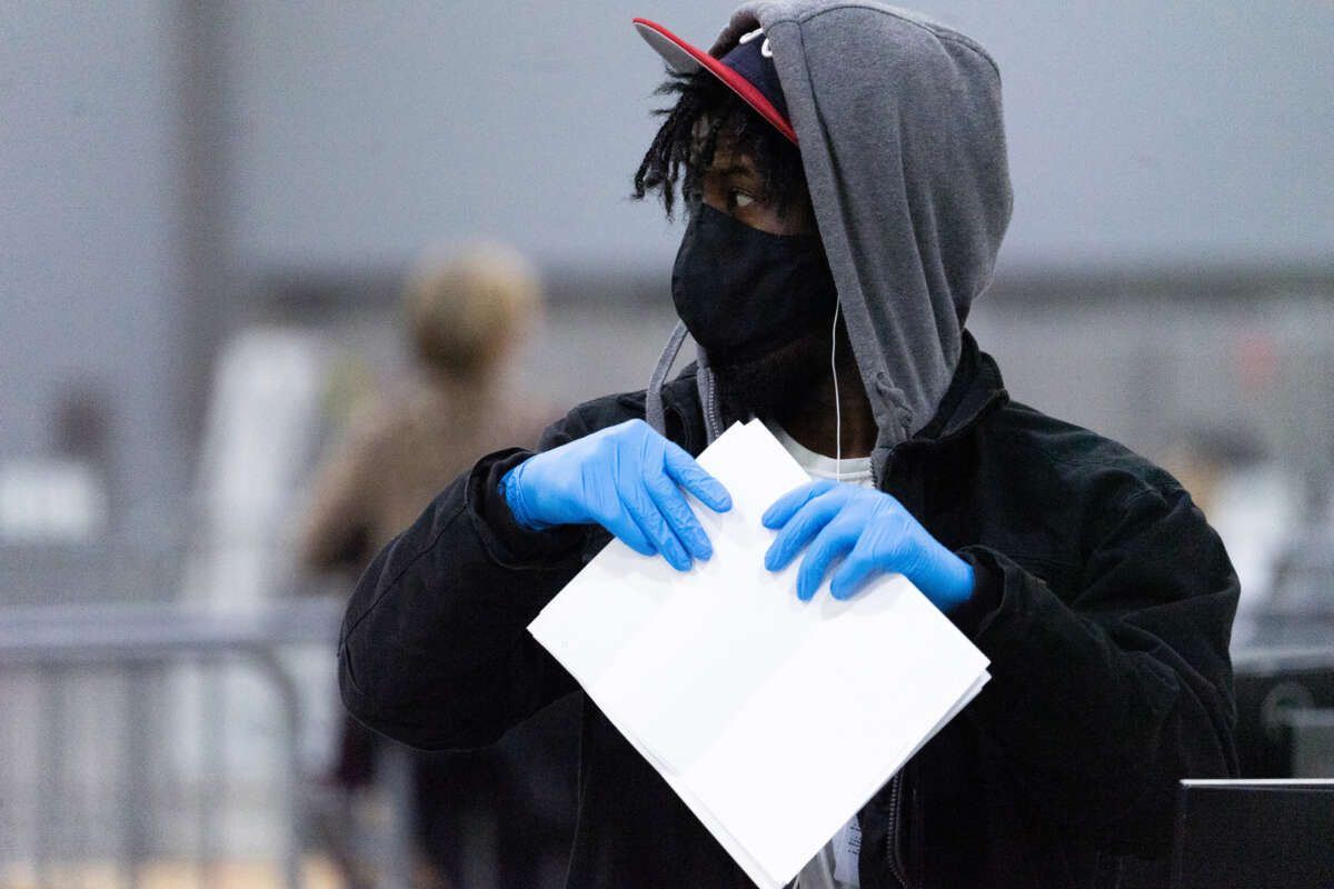 Election officials count the votes for Fulton County on January 6, 2021, in Atlanta, Georgia.