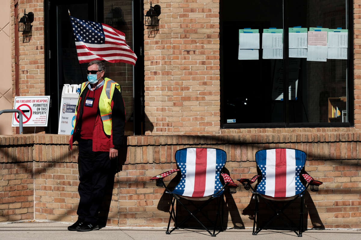 A poll worker sits outside and assists voters at a polling station at the Congregation Agudas Achim on November 3, 2020, in Bexley, Ohio.