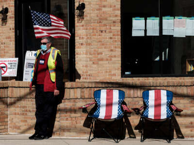 A poll worker sits outside and assists voters at a polling station at the Congregation Agudas Achim on November 3, 2020, in Bexley, Ohio.