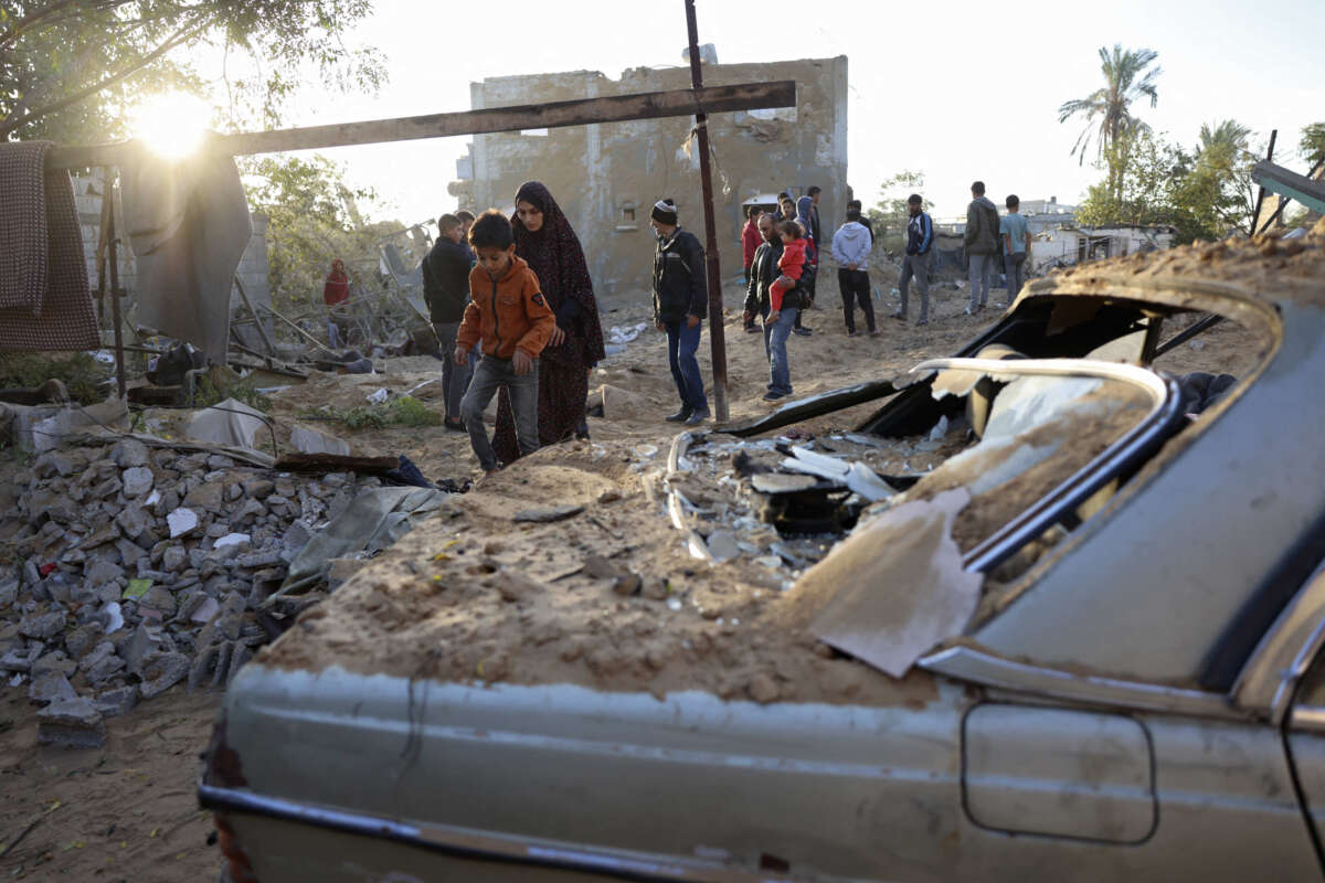 People inspect the damage at the site of an Israeli strike that targeted an area in Khan Yunis on the southern Gaza Strip on October 25, 2024.