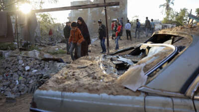People inspect the damage at the site of an Israeli strike that targeted an area in Khan Yunis on the southern Gaza Strip on October 25, 2024.