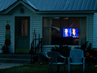 A television playing the U.S. presidential debate is seen through a residential home's window