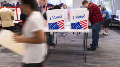 Voters work on their ballot at a polling station at the Elena Bozeman Government Center in Arlington, Virginia, on September 20, 2024.