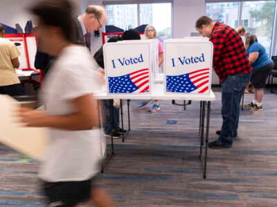 Voters work on their ballot at a polling station at the Elena Bozeman Government Center in Arlington, Virginia, on September 20, 2024.