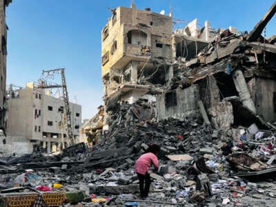 A Palestinian girl inspects the rubble of a building after an Israeli strike in Beit Lahiya, in the northern Gaza Strip, on October 29, 2024.