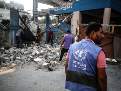 A member of the United Nations is checking the destruction at a school run by the UN Relief and Works Agency for Palestine Refugees (UNRWA) that was previously hit by Israeli bombardment, in the Nuseirat camp in the central Gaza Strip on July 15, 2024.