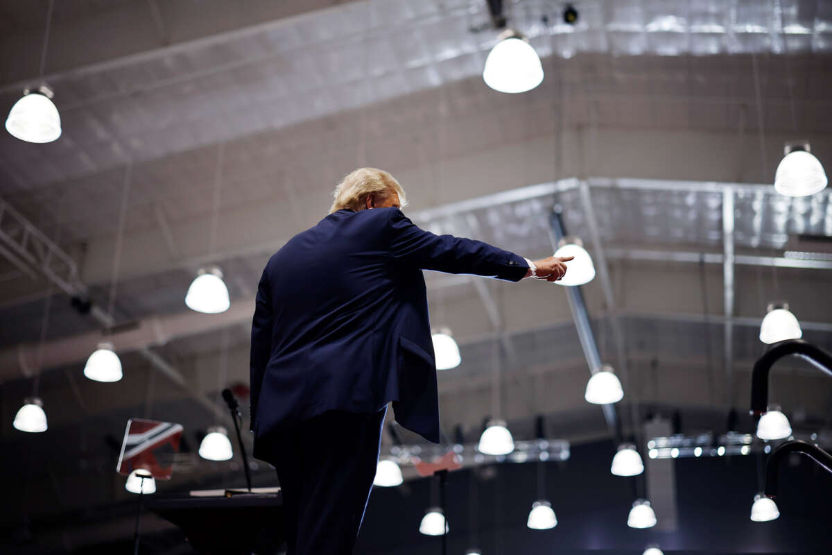 Donald Trump points to someone as he walks offstage