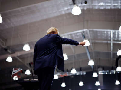 Donald Trump points to someone as he walks offstage