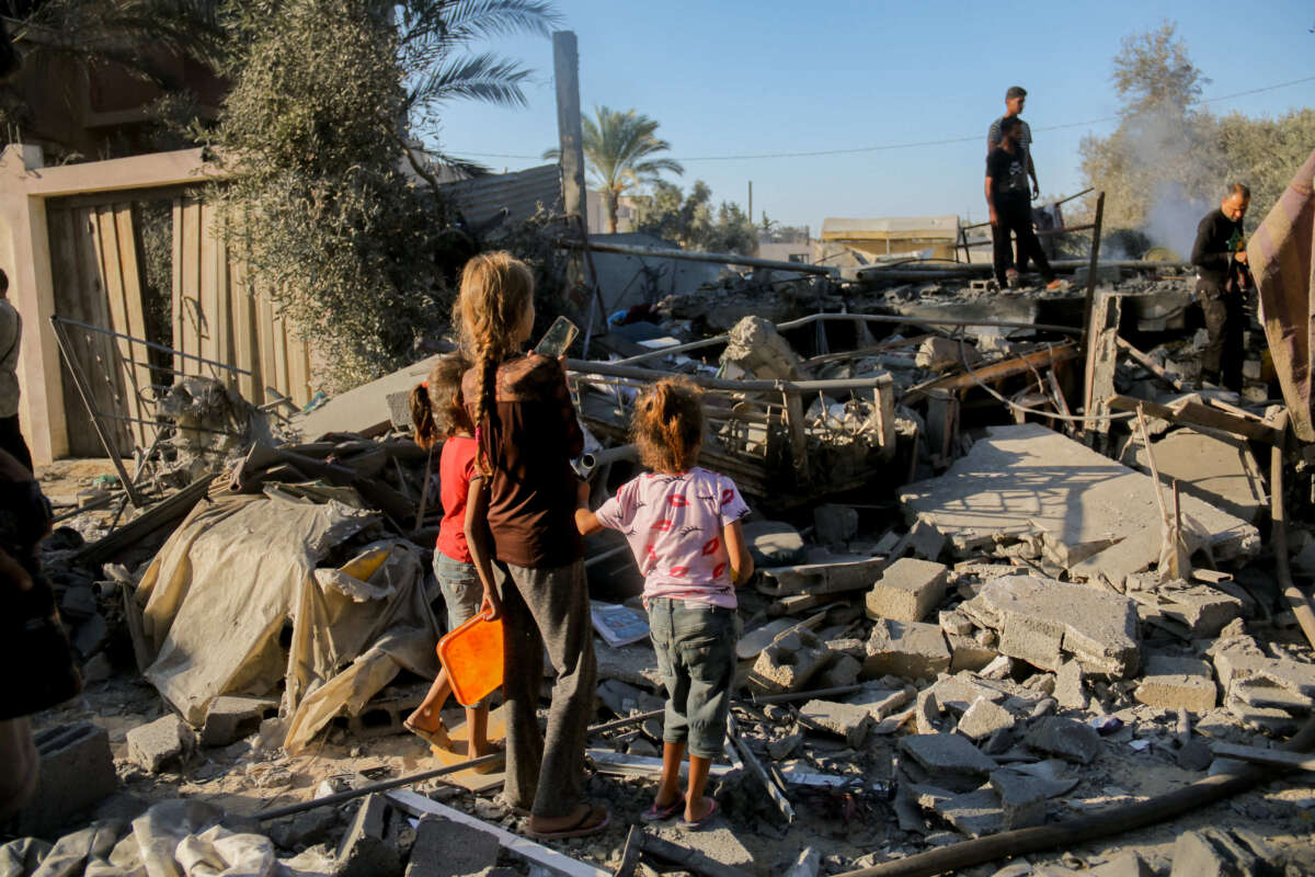 Palestinian children amongst the debris following an Israeli airstrike in Deir al-Balah, central Gaza, on October 4, 2024.