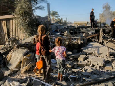 Palestinian children amongst the debris following an Israeli airstrike in Deir al-Balah, central Gaza, on October 4, 2024.