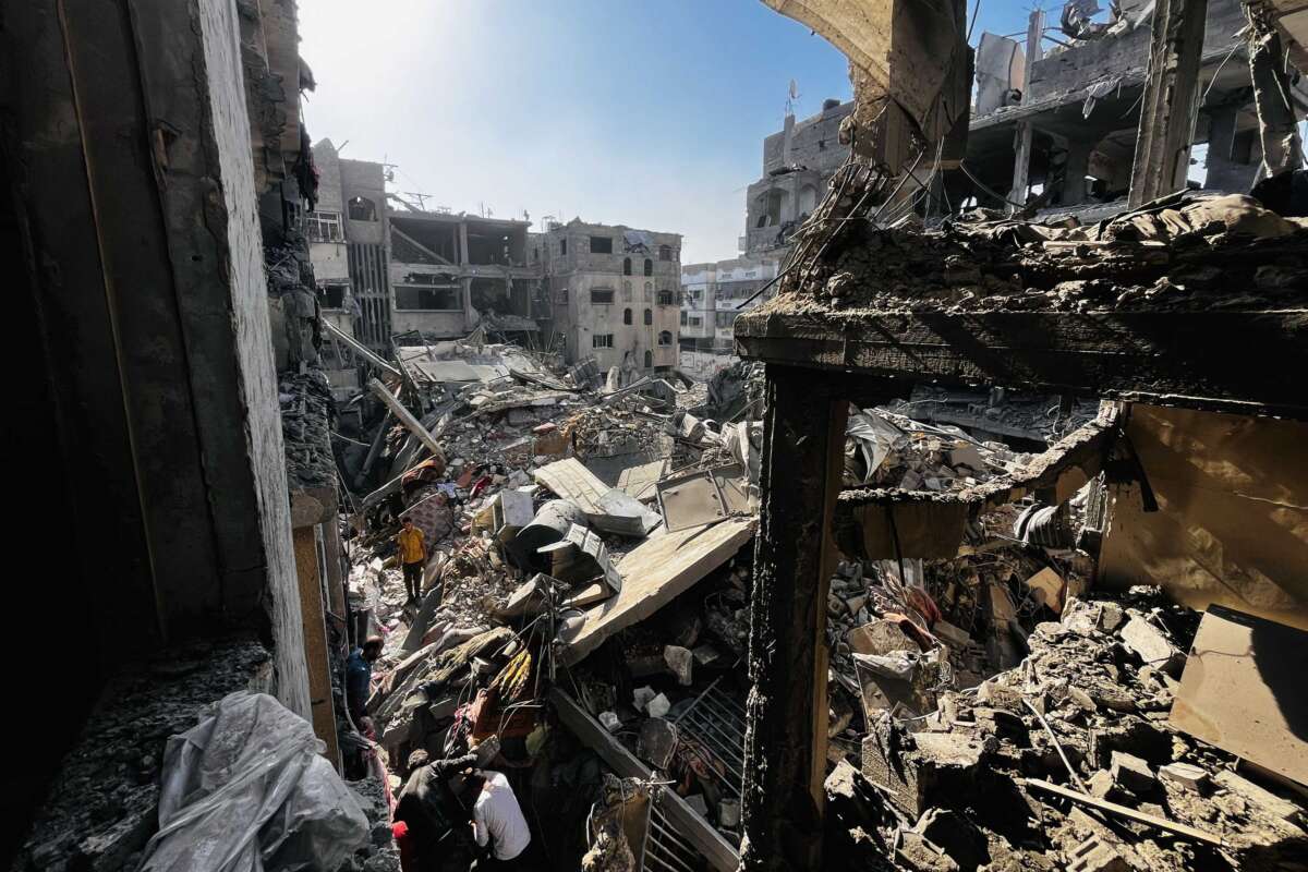 Palestinians search through the rubble of a building after an Israeli strike in Beit Lahia, in the northern Gaza Strip, on October 29, 2024.