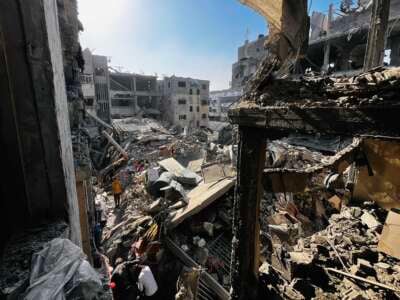 Palestinians search through the rubble of a building after an Israeli strike in Beit Lahia, in the northern Gaza Strip, on October 29, 2024.