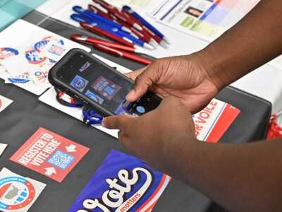 Zachari Barnes, a freshman from Baltimore, scans a QR code in order to complete his voter registration on October 29, 2024.