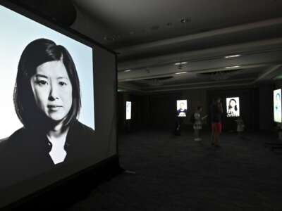 Visitors look at a film project on adoption in South Korea, Side by Side, directed by Korean American adoptee Glenn Morey at a exhibition hall in Seoul, South Korea, on July 31, 2019.