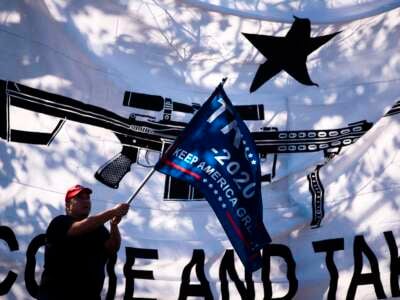 Protesters fly pro-Trump and pro-gun flags outside of then-Democratic presidential candidate Mike Bloomberg’s speaking engagement at the Viva Villa restaurant in San Antonio, Texas, on January 11, 2020.