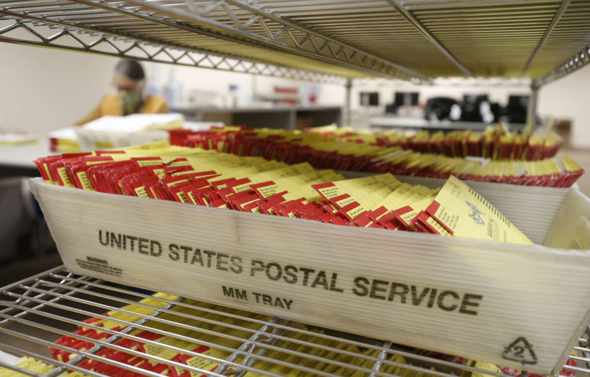 Mail-in ballots sit in containers from the U.S. Postal Service waiting to be processed by election workers at the Salt Lake County election office in Salt Lake City, Utah, on October 29, 2020.