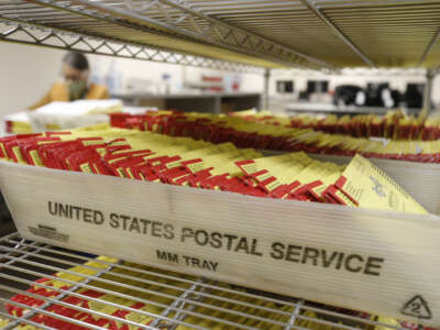 Mail-in ballots sit in containers from the U.S. Postal Service waiting to be processed by election workers at the Salt Lake County election office in Salt Lake City, Utah, on October 29, 2020.