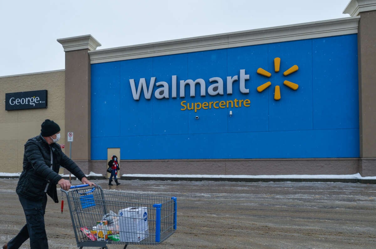 A man pushes a cart in front of a Walmart store on January 12, 2021, in Edmonton, Alberta, Canada.