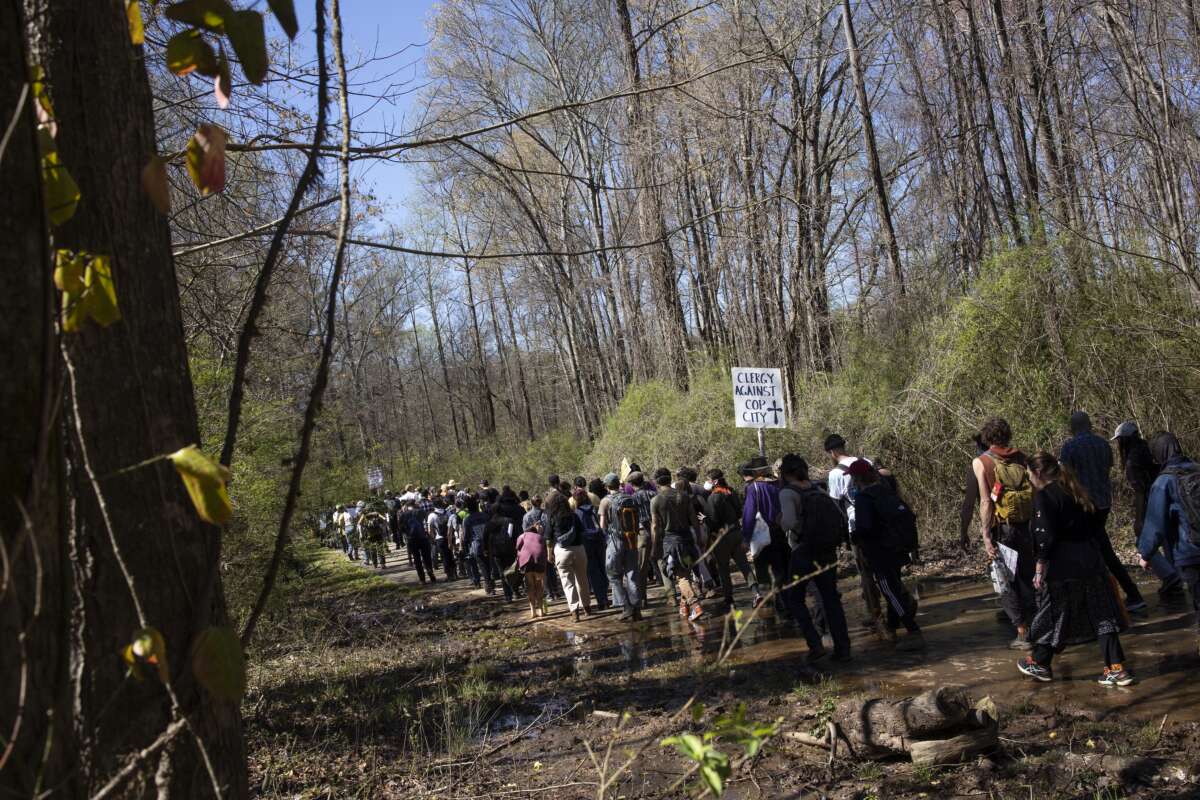 Environmental activists hold a rally and a march through the Atlanta Forest, a preserved forest that is scheduled to be developed as a police training center, on March 4, 2023, in Atlanta, Georgia.