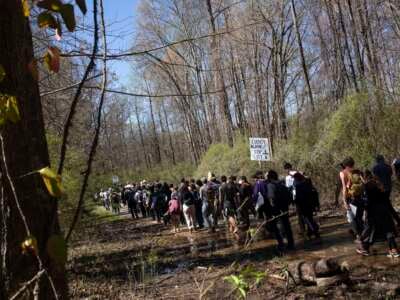 Environmental activists hold a rally and a march through the Atlanta Forest, a preserved forest that is scheduled to be developed as a police training center, on March 4, 2023, in Atlanta, Georgia.