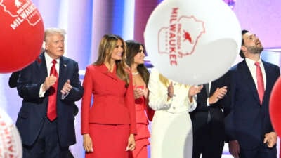 Balloons fall as Donald Trump stands alongside Melania Trump and family after he accepted his party's nomination on the last day of the 2024 Republican National Convention in Milwaukee, Wisconsin, on July 18, 2024.