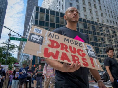 A participant holds a sign at a protest in honor of International Overdose Awareness Day outside New York Governor Kathy Hochul's Manhattan office to push back against the governor's proposed plans to increase criminalization to address the overdose crisis, on August 28, 2024, in New York City.