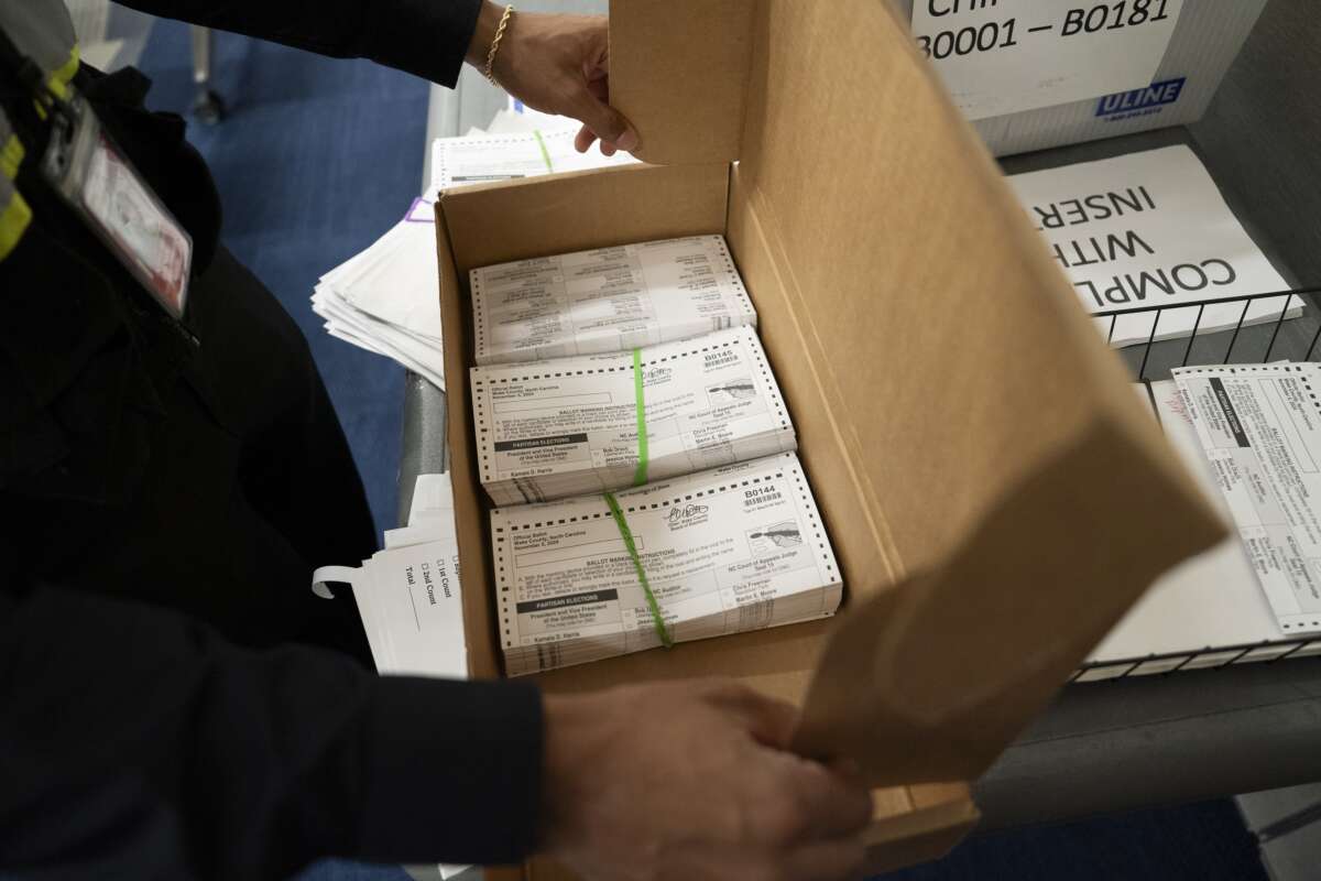 Absentee ballots are prepared to be mailed to military and overseas citizens at the Wake County Board of Elections on September 17, 2024, in Raleigh, North Carolina.