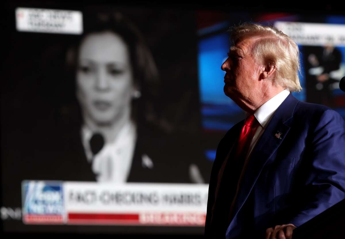 Donald Trump watches a video of Kamala Harris during a campaign rally at The Expo at World Market Center Las Vegas on September 13, 2024, in Las Vegas, Nevada.