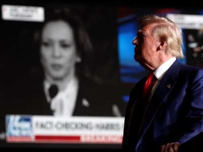 Donald Trump watches a video of Kamala Harris during a campaign rally at The Expo at World Market Center Las Vegas on September 13, 2024, in Las Vegas, Nevada.